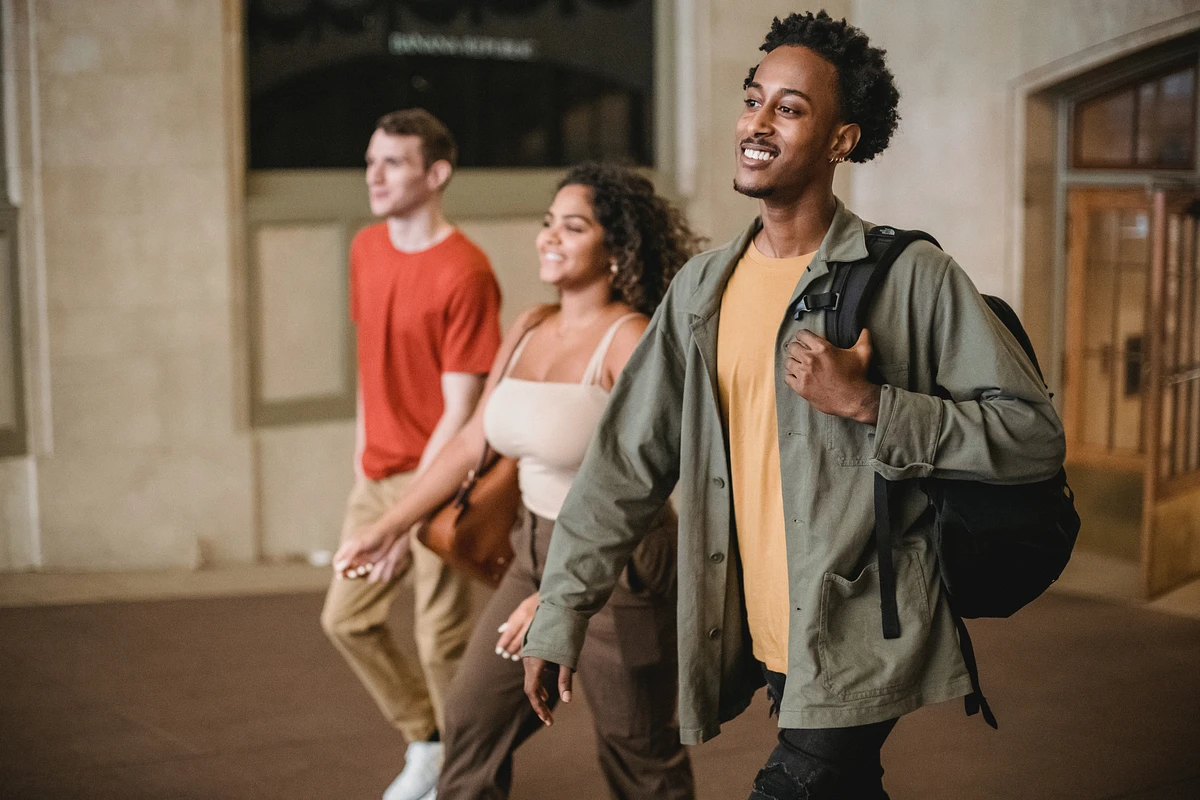 Three students walking through building